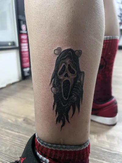 Ghostface tattoo on the back of a client's calf