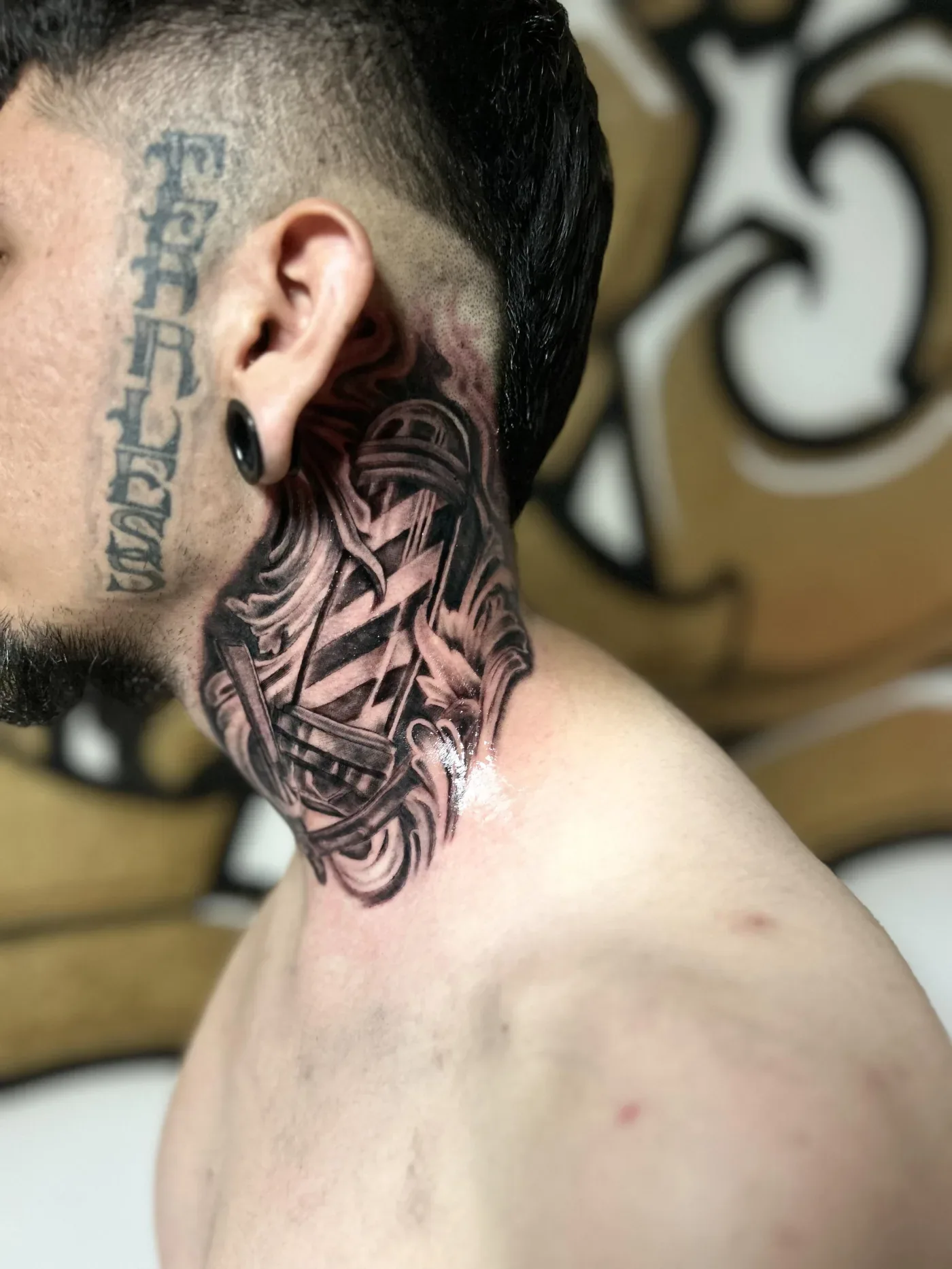 Neck and head tattoo in fine black linework