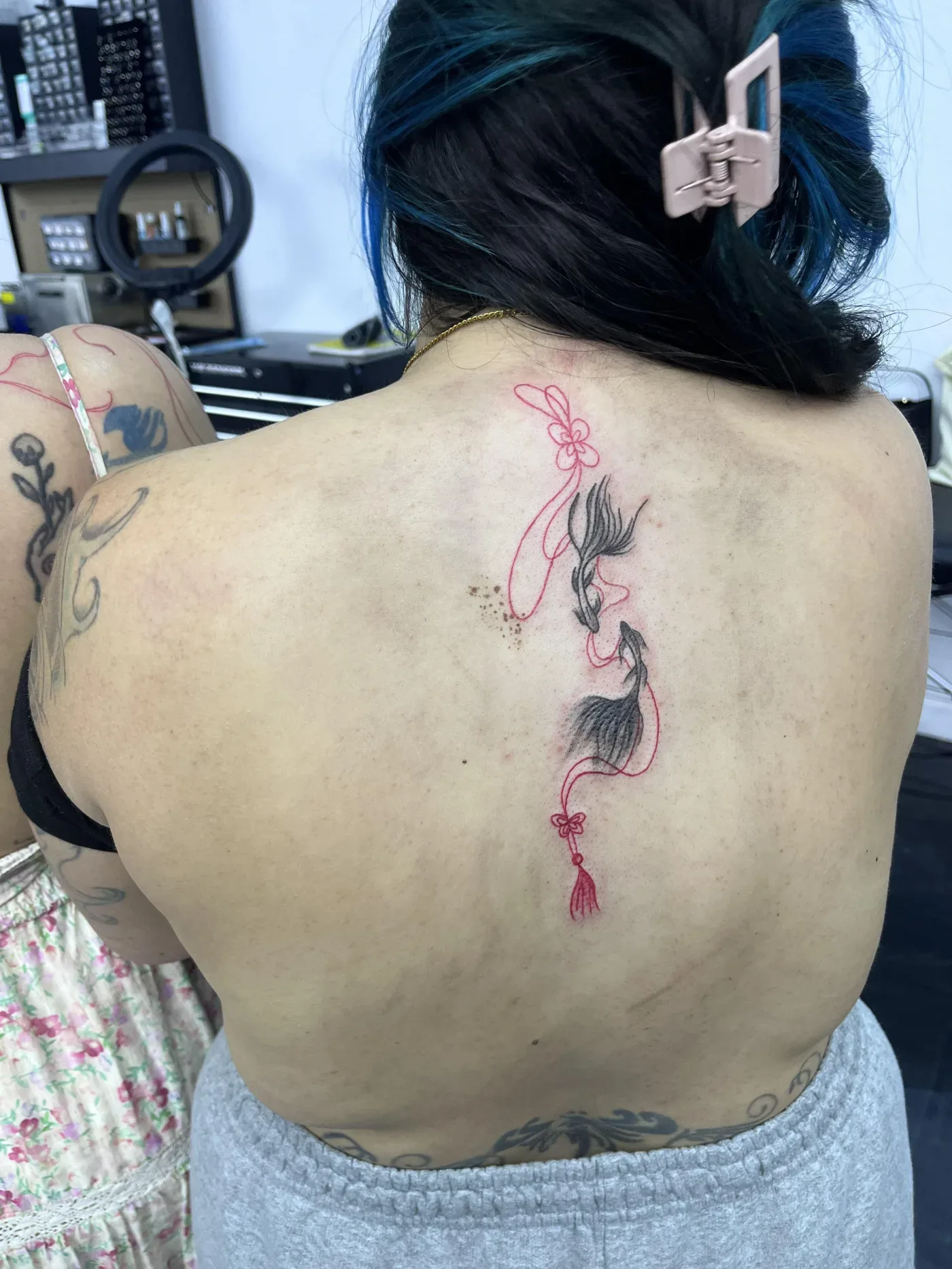 Freshly finished back tattoo with fine script