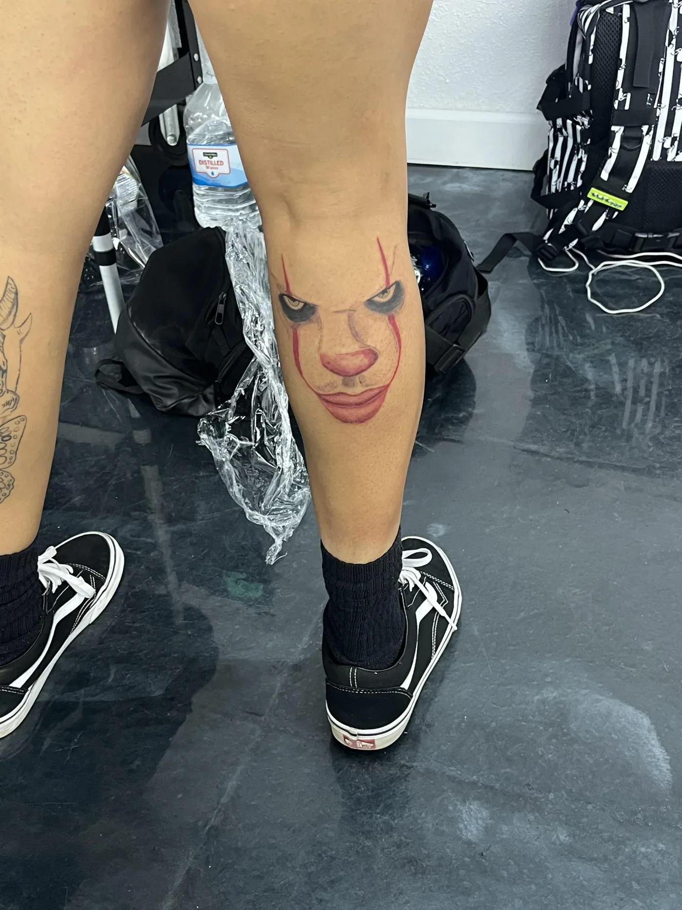 Portrait tattoos running down a client's lower leg