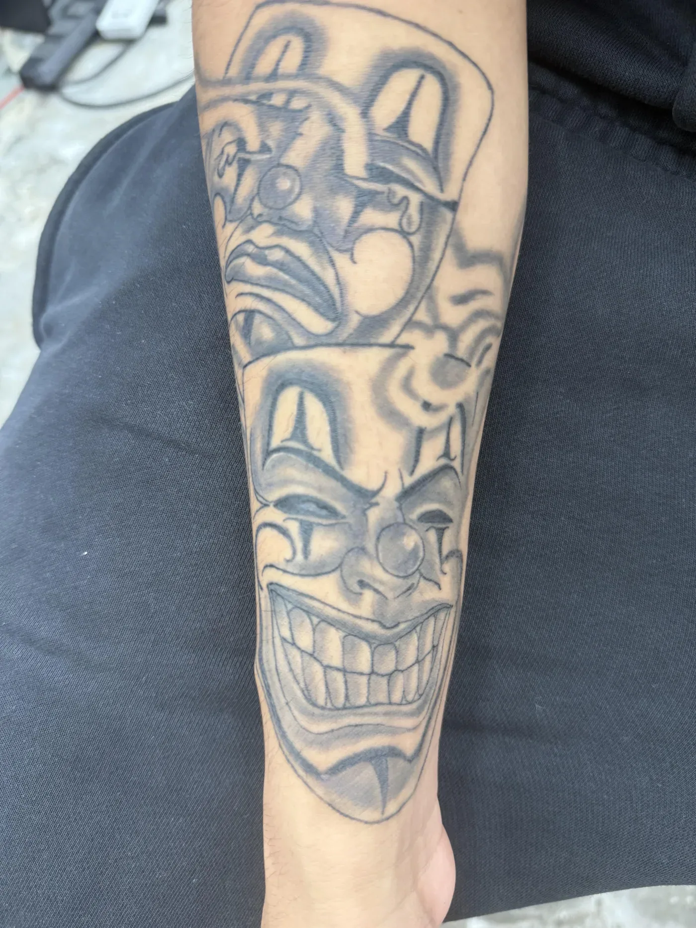 Black and gray religious forearm tattoo with heavy shading