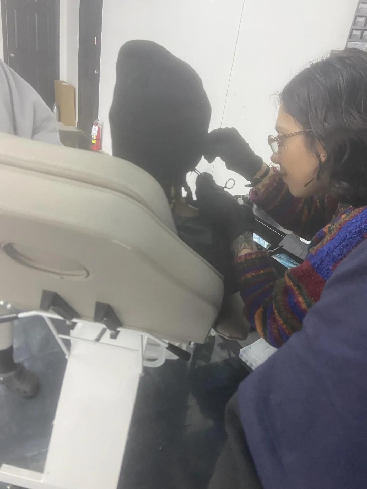Client seated in the piercing chair at InkSquad Studio in Phoenix