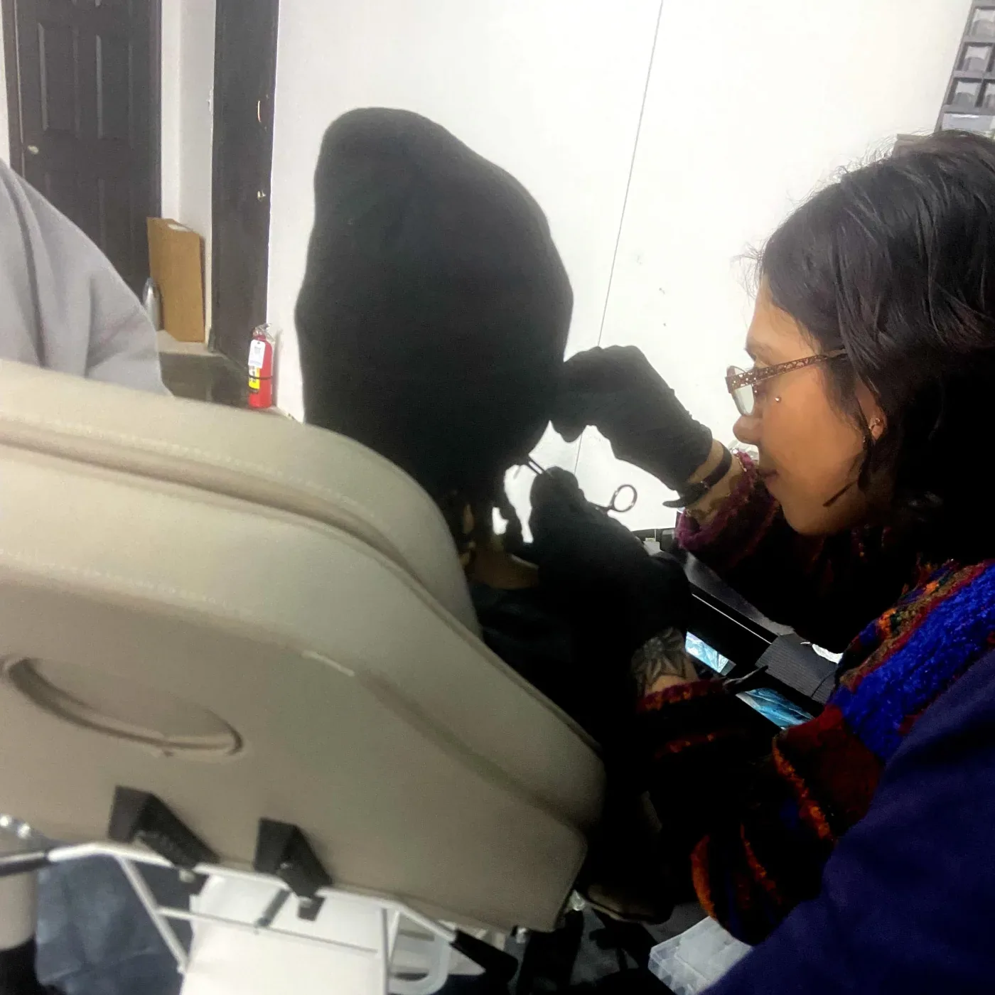 Piercer preparing sterile equipment before a dermal anchor procedure