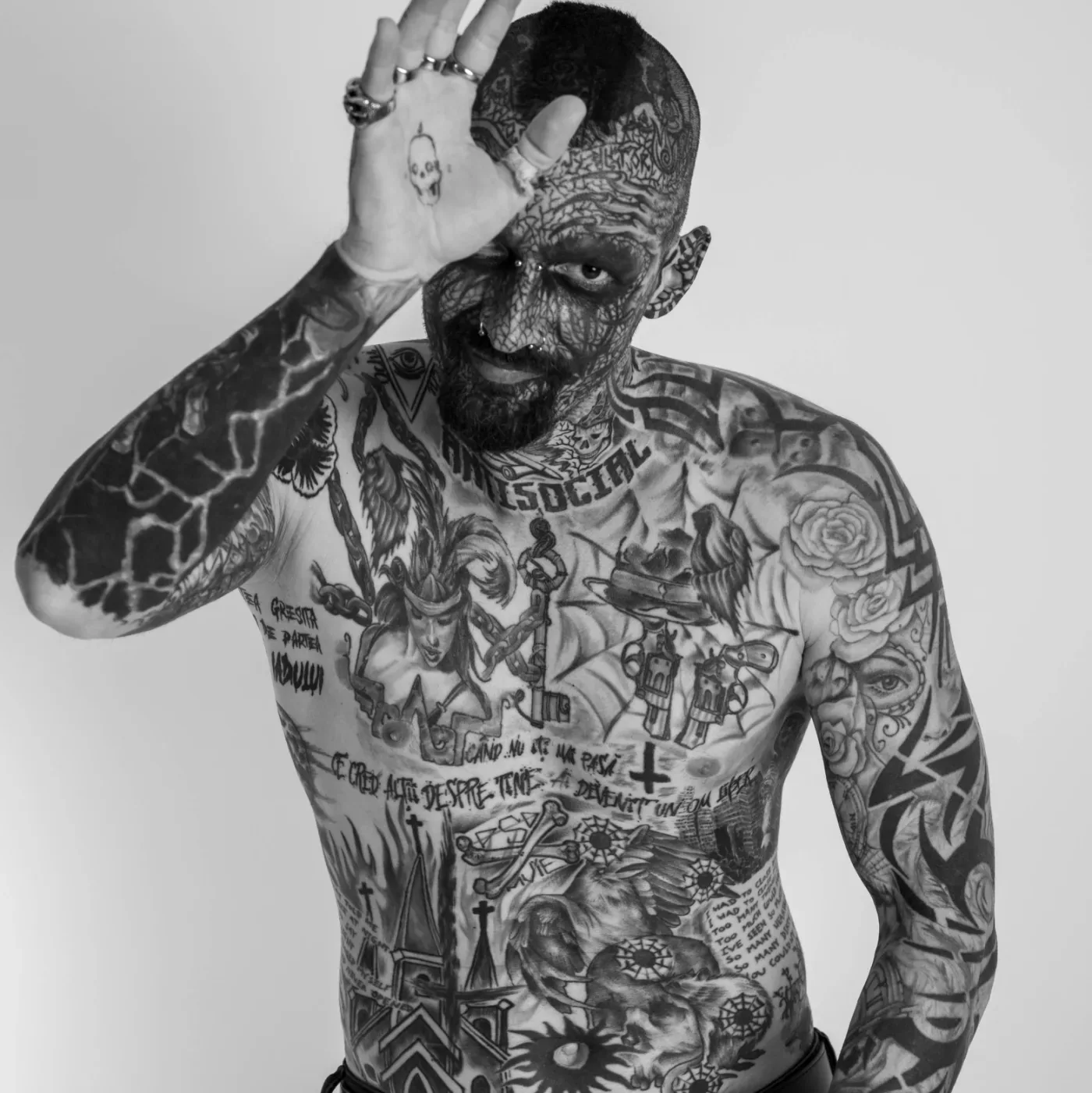 Client covered in large scale black and gray tattoo work across the chest and arms